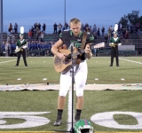 No one was willing to sing the national anthem, so one high schooler took off his helmet and grabbed a guitar